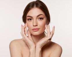 Portrait of young beautiful woman with perfect smooth skin isolated on white background. Taking care after skin condition. Concept of natural beauty, plastic surgery, cosmetology, cosmetics, skin care